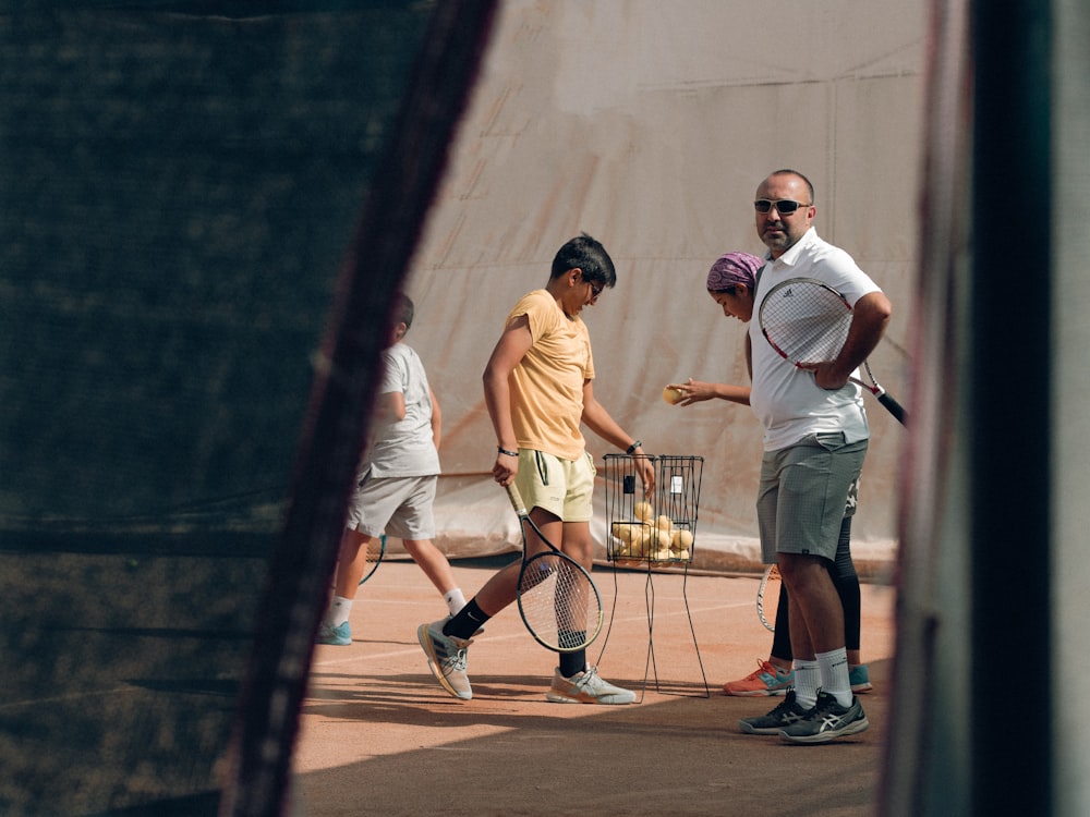 a group of people stand around a tennis racket