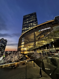 Osaka city night skyline with illuminated buildings reflecting a vibrant business atmosphere.