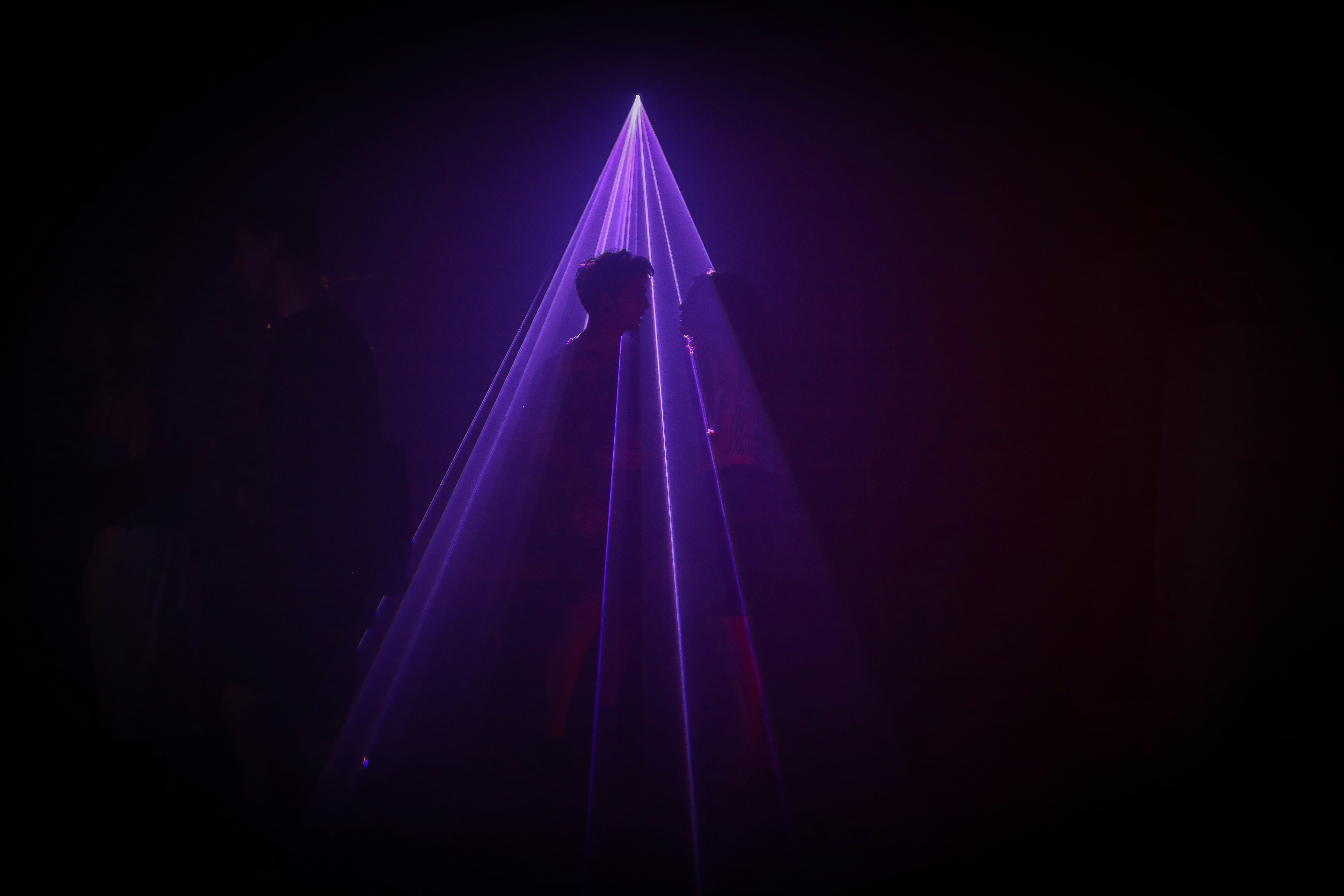 a person standing next to a triangular structure