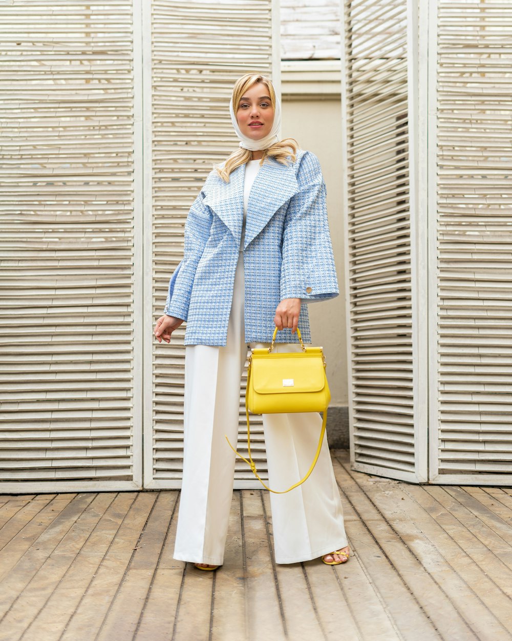 a person holding a yellow suitcase