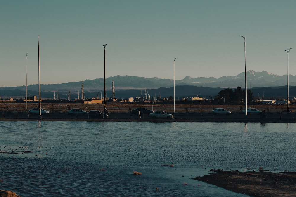 a body of water with boats in it and a city in the background