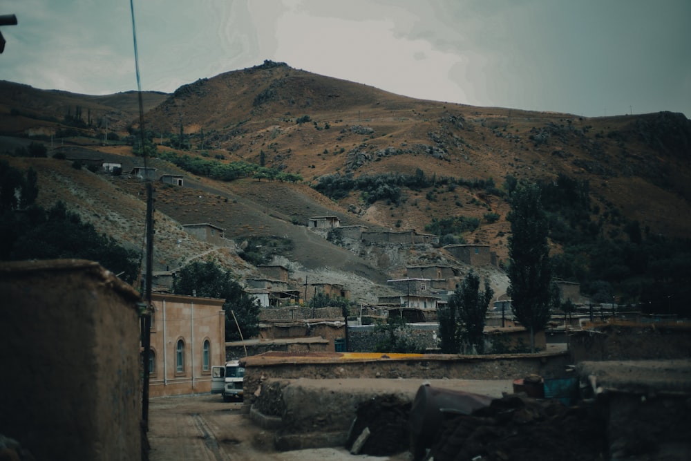 a hill with a building and a hill in the background