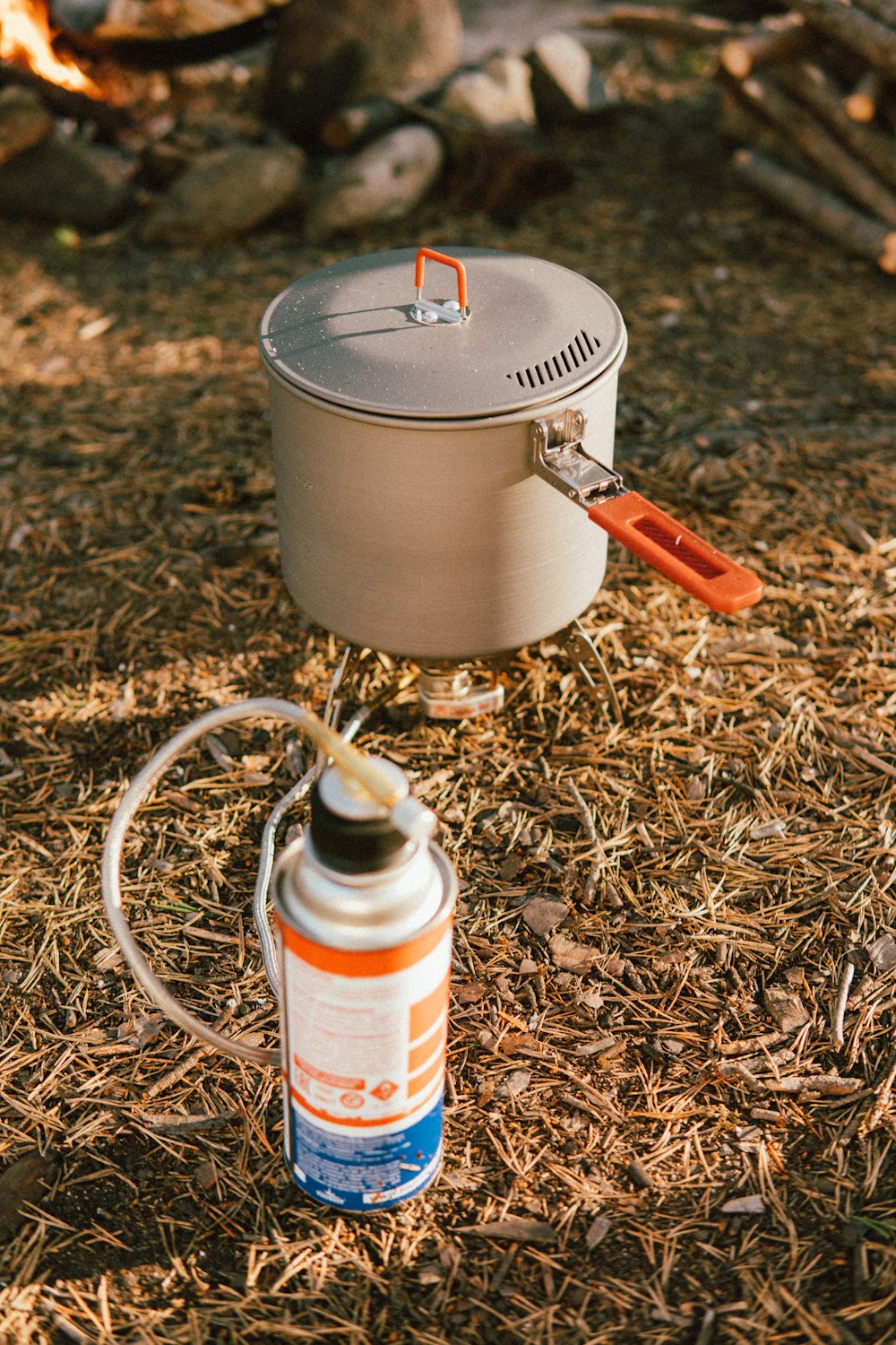 a can of paint and a bottle of paint on the ground