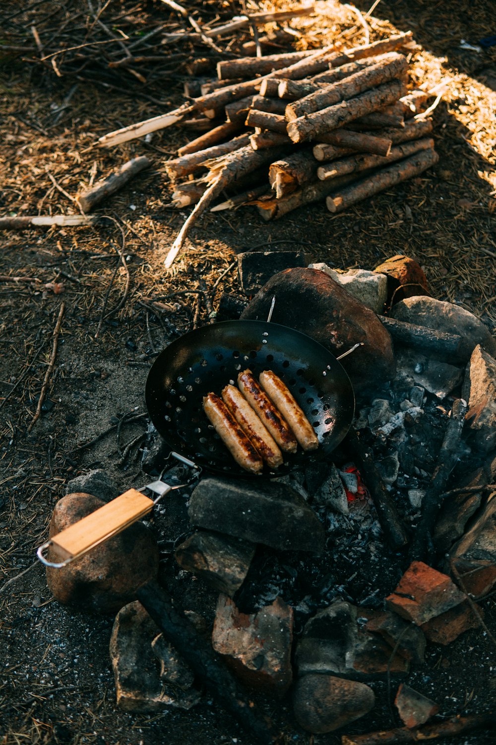 a grill with meat and a cigarette