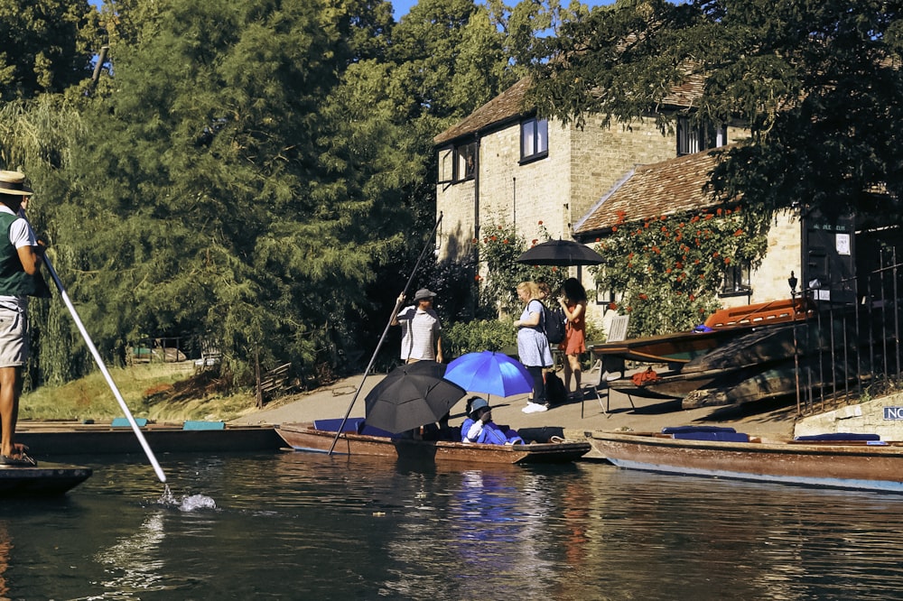 people on a boat with umbrellas