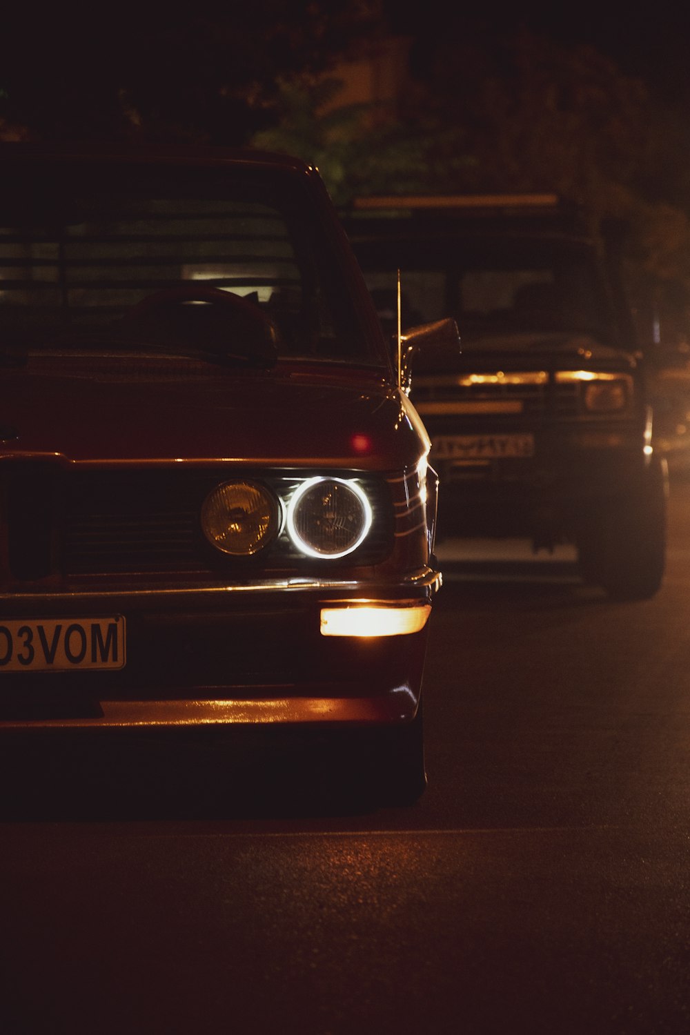 a group of cars on a road at night