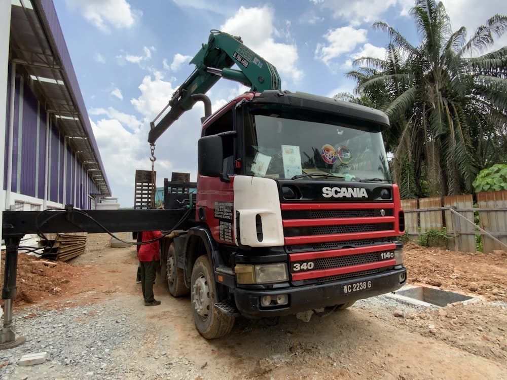 a red truck with a crane on top of it