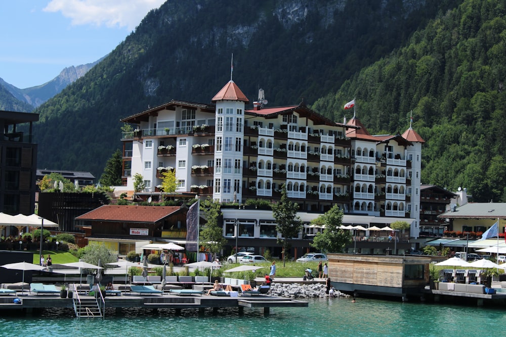 a large white building next to a body of water