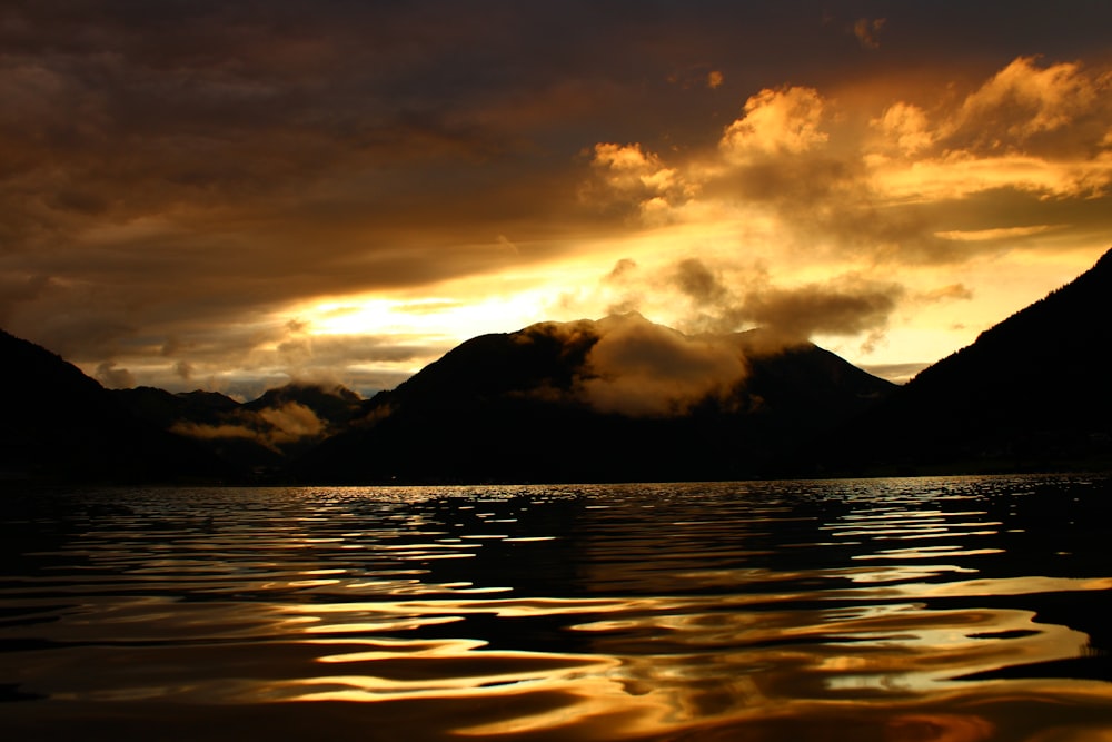 a body of water with mountains in the background