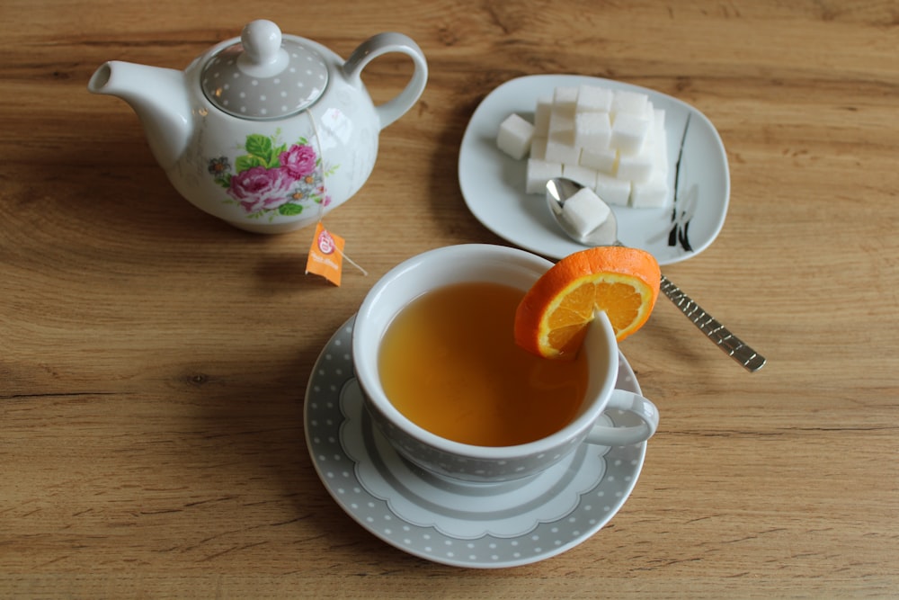 a teapot and tea cup on a table