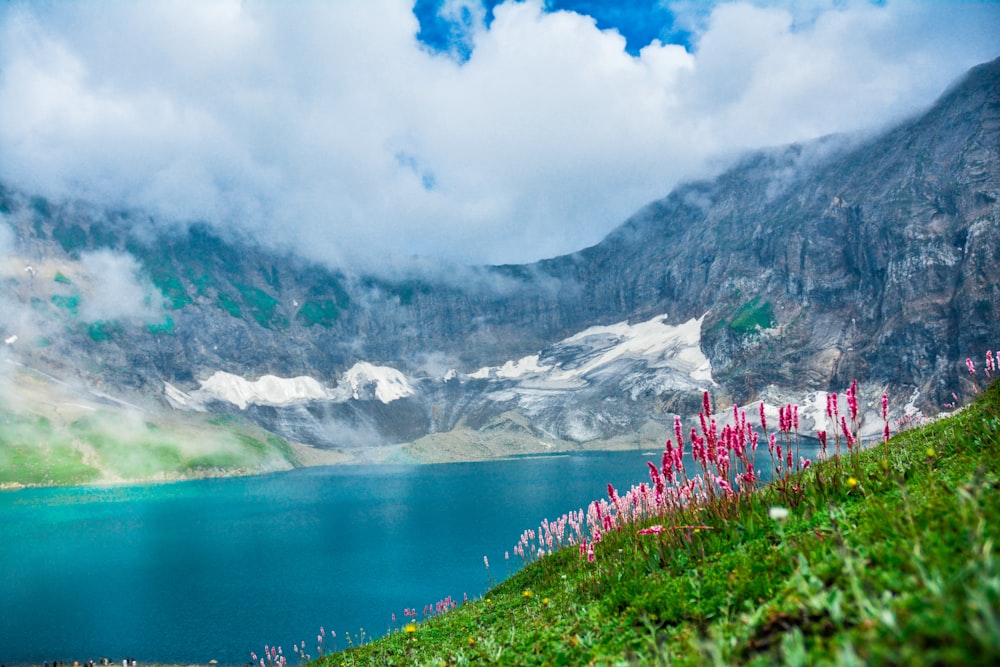 a body of water with mountains in the background