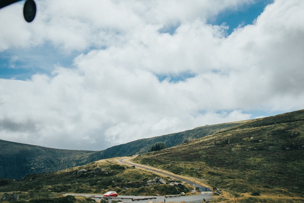 a car driving on a road in a valley