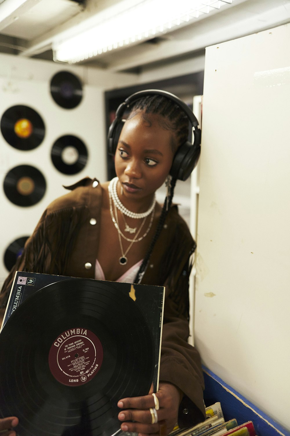 a person wearing headphones and holding a black box