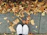 Close-up of a pair of stylish urban shoes on a city sidewalk with autumn leaves.