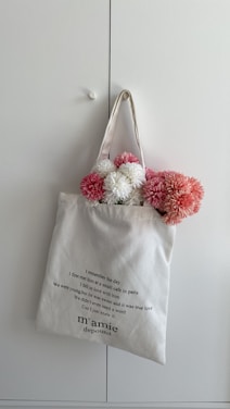 a white bag with pink flowers