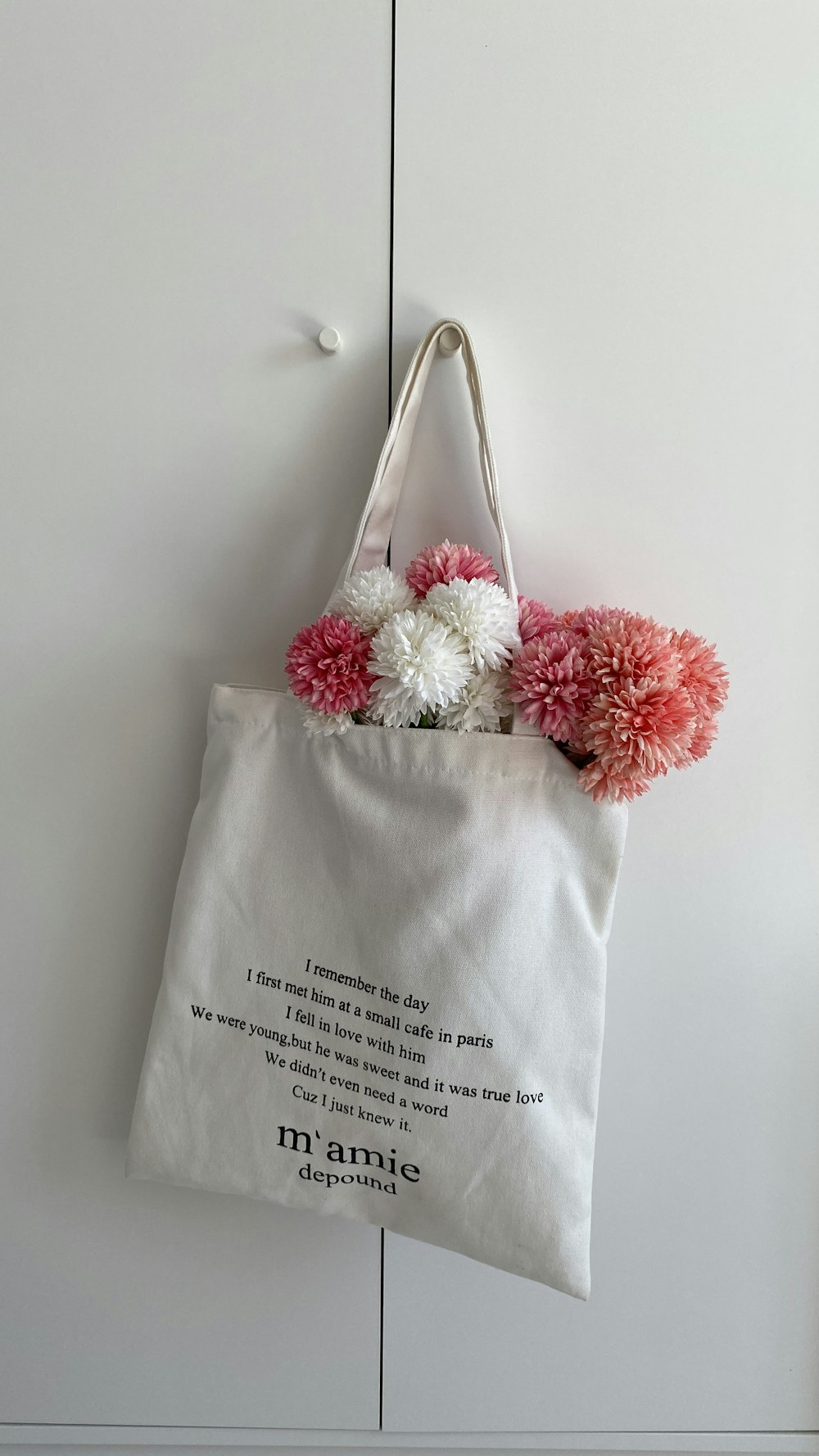 a white bag with pink flowers