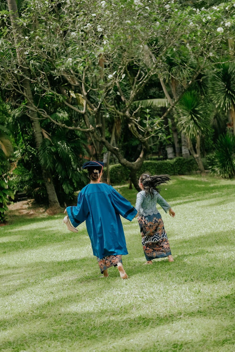 two women running on a grass field