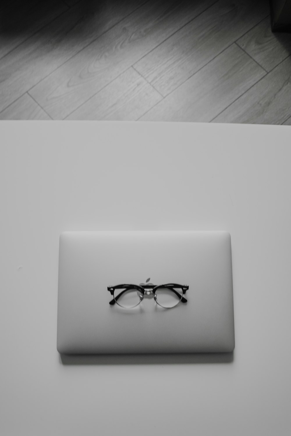 a pair of glasses on a white surface