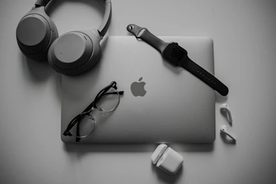 A collection of tech accessories including headphones, mouse, and keyboard arranged neatly.