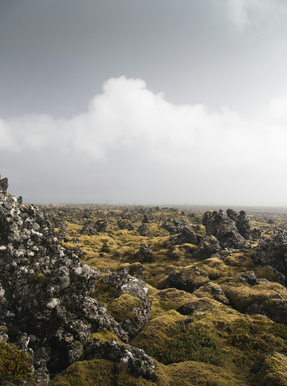 a rocky landscape with a cloudy sky