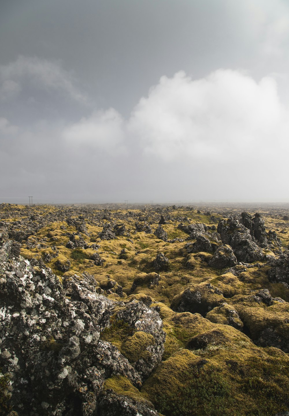 a rocky area with a cloudy sky