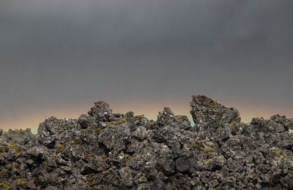 a rocky area with a cloudy sky