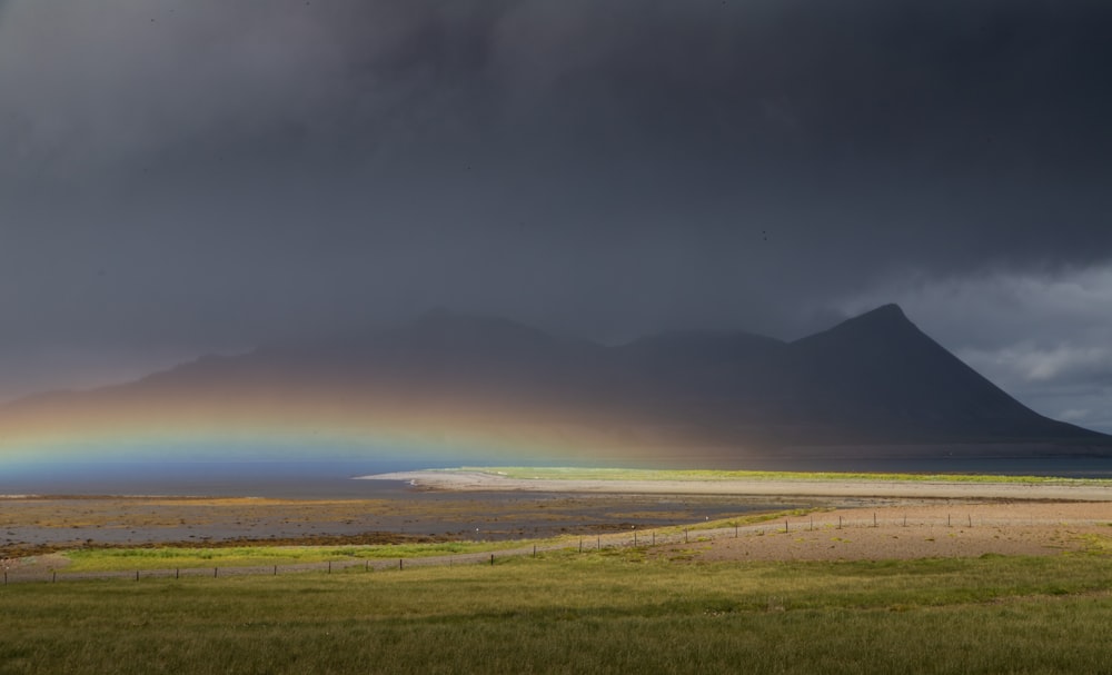 a field with a mountain in the background