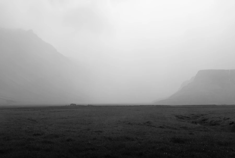 Open grassy field with soft hills on the horizon