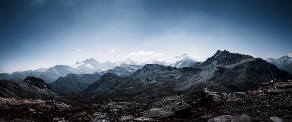 a rocky landscape with mountains in the back