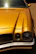A restored classic car gleaming under sunlight, showcasing a shiny new part from Valour Garage.