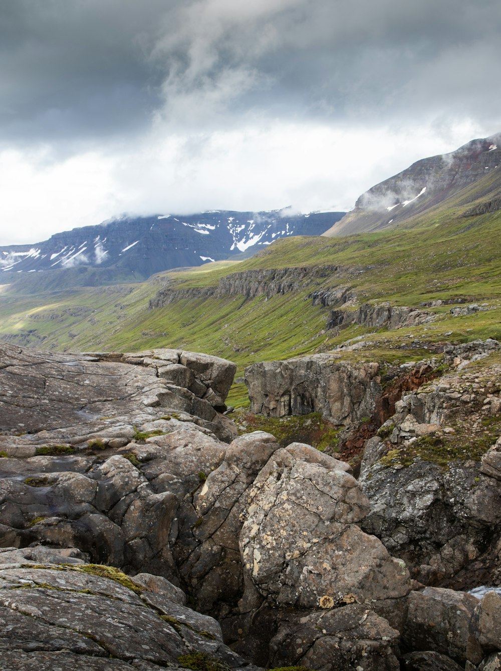 a rocky river bed in a valley