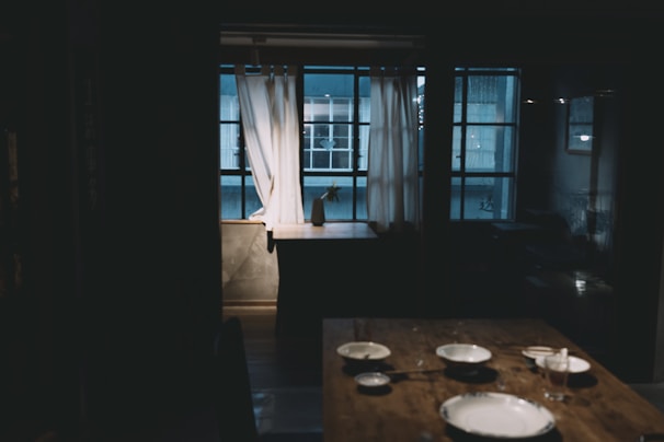 Intimate dining space set for a home-cooked meal with soft ambient lighting.