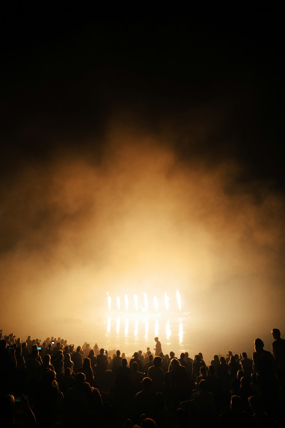 a group of people watching a fire