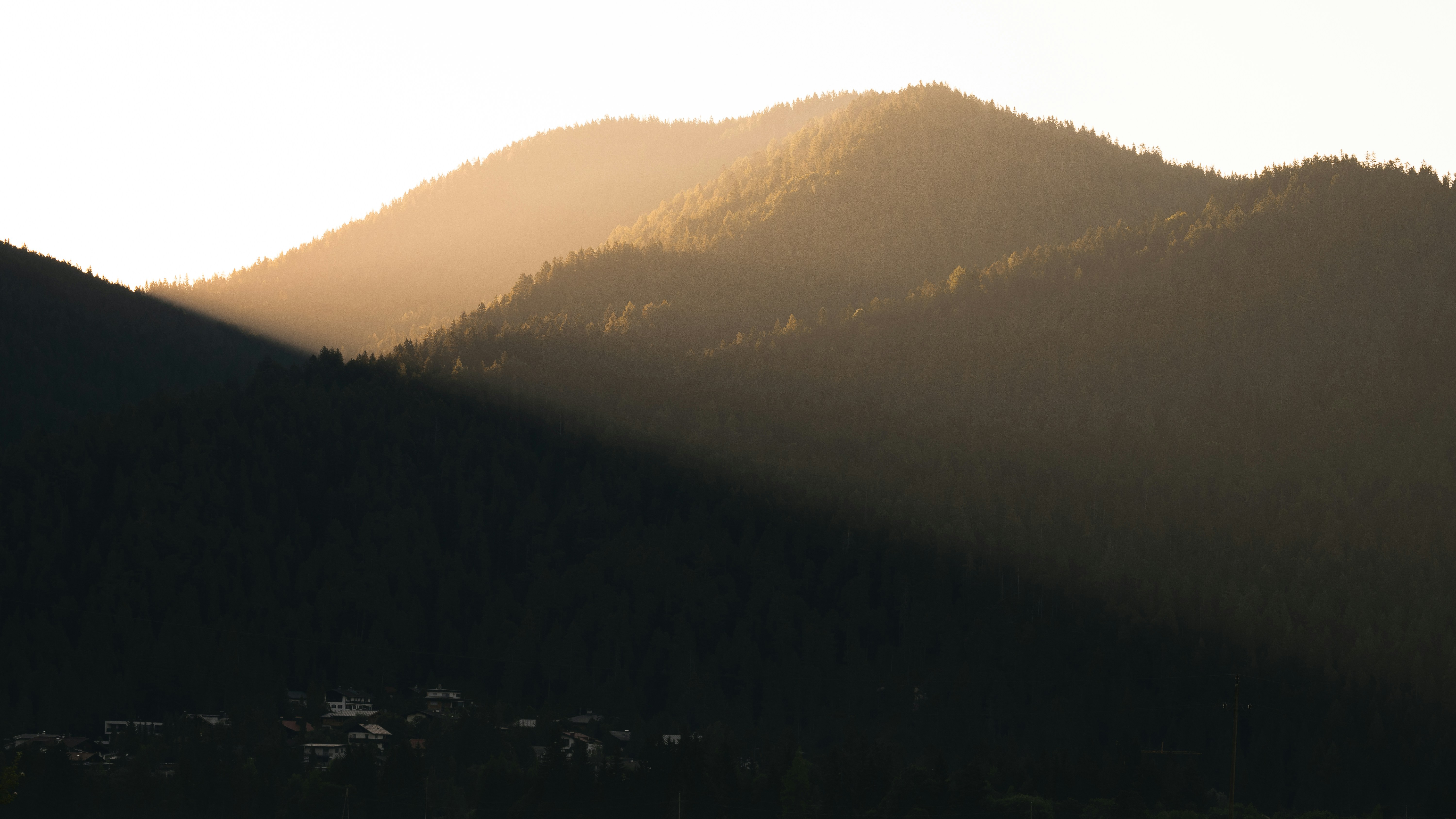 a mountain with a foggy sky