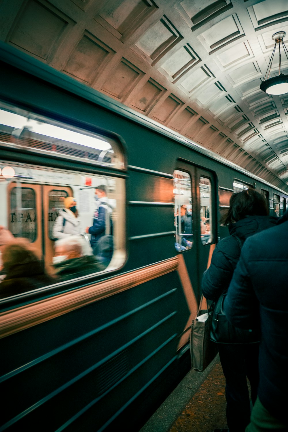 a person stands on a train