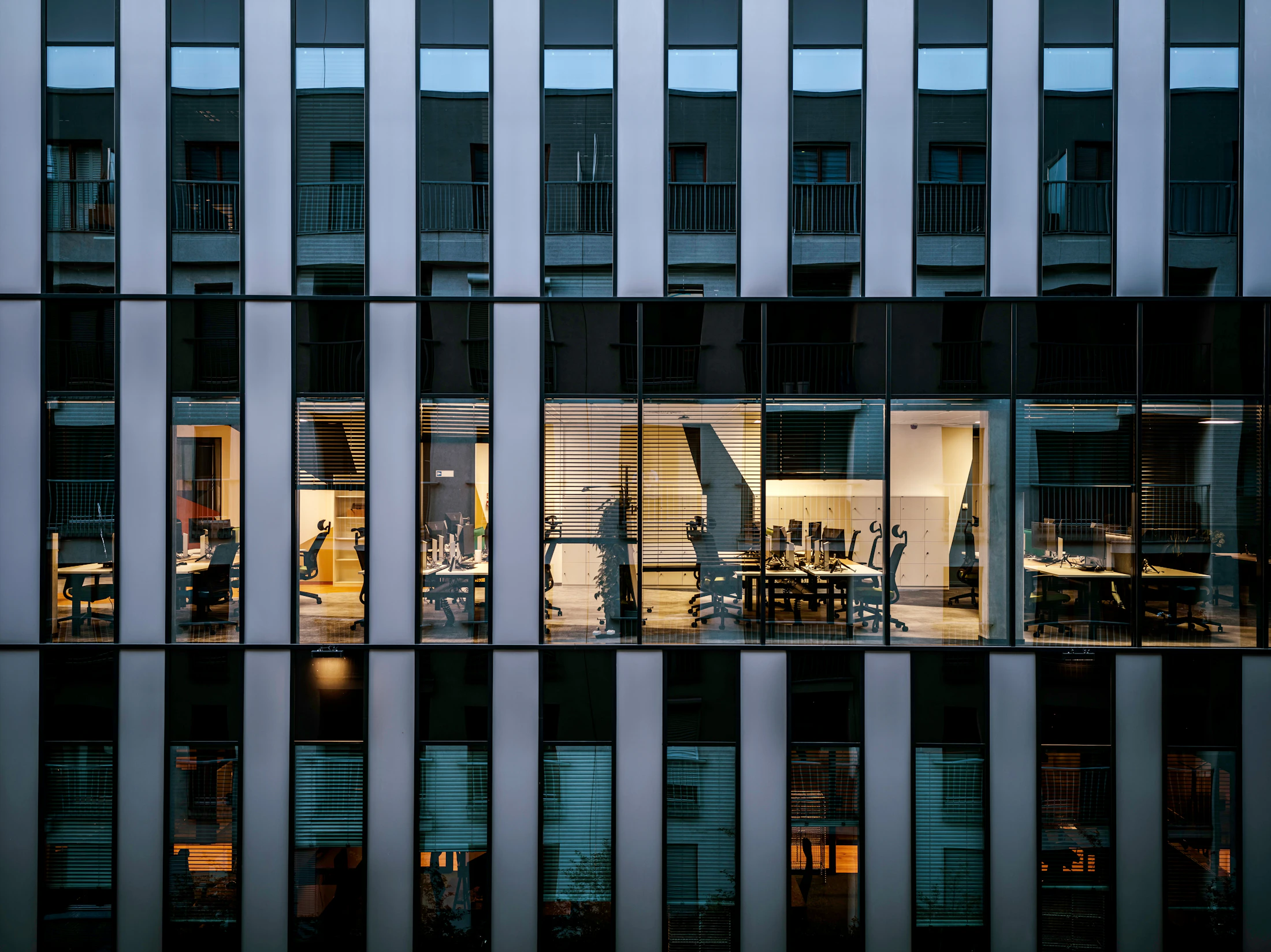 A glass office facade at night