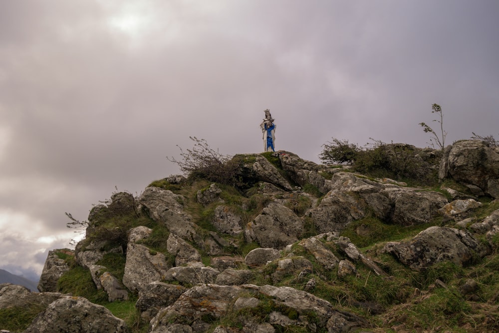 a person standing on a rocky hill