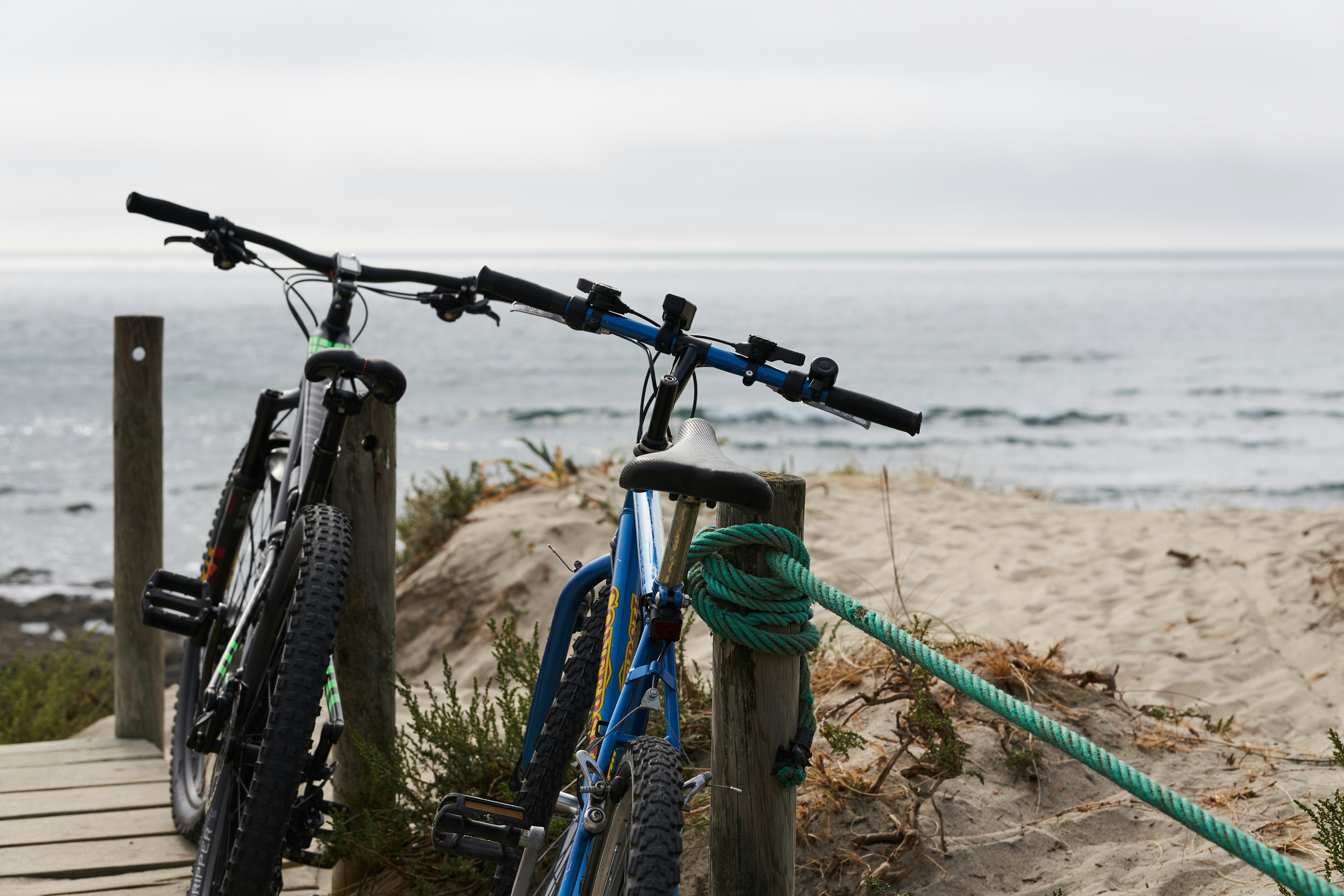 a couple of bikes parked on a wooden dock by the water