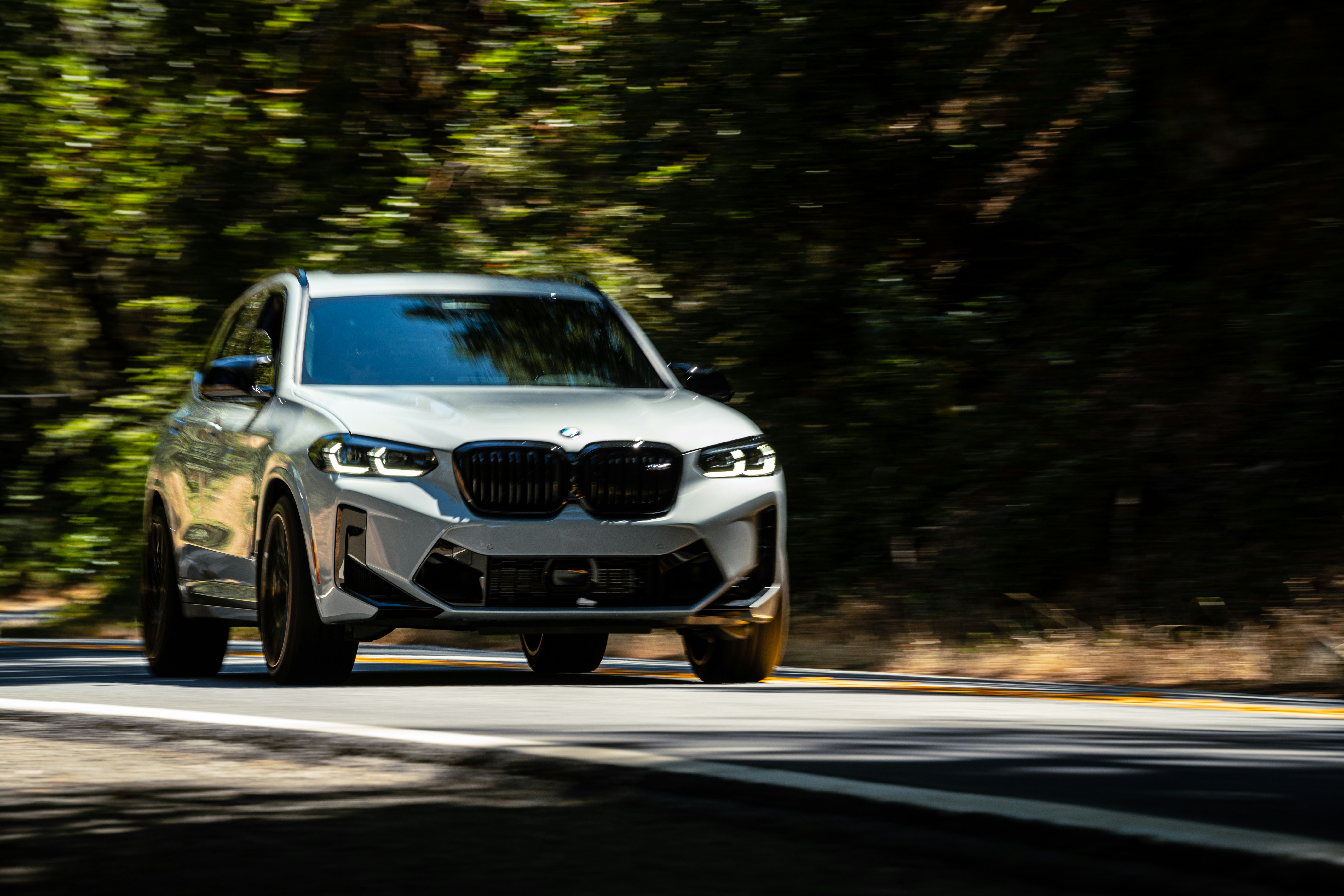 a white car driving on a road