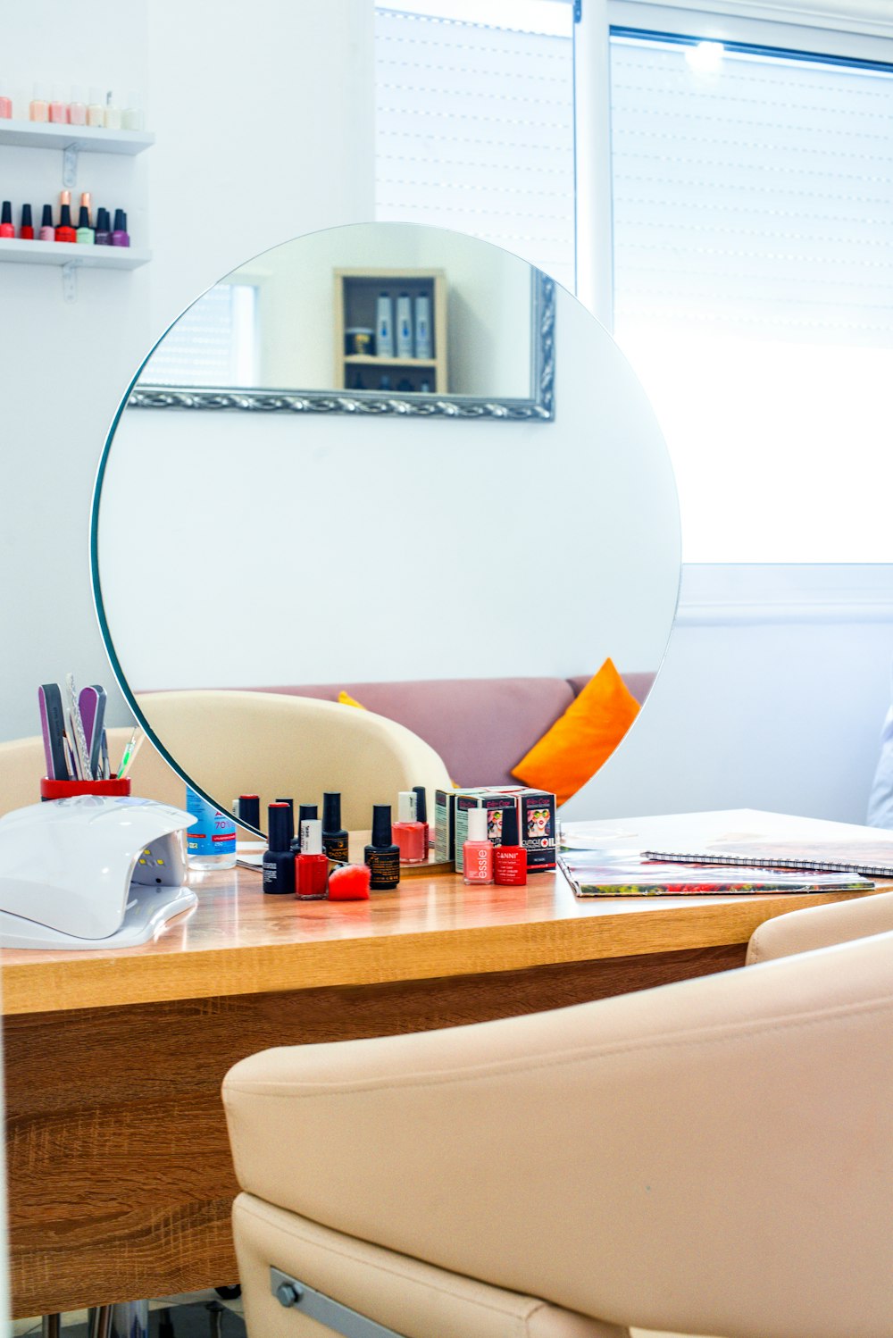 a desk with a lamp and a mirror