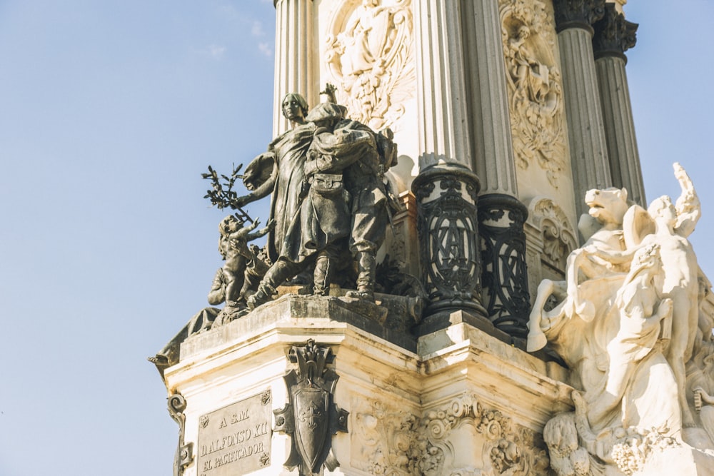 a statue of a man holding a staff and a woman holding a staff