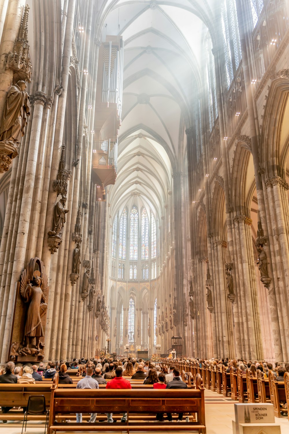 a large cathedral with people sitting in pews