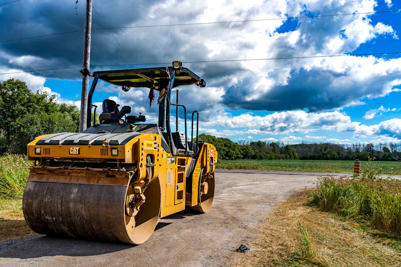 Large yellow construction vehicle on a road — parts and support available