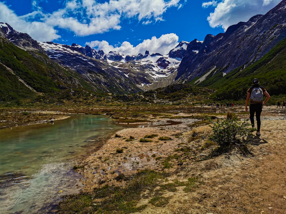 a man walking on a trail in the mountains