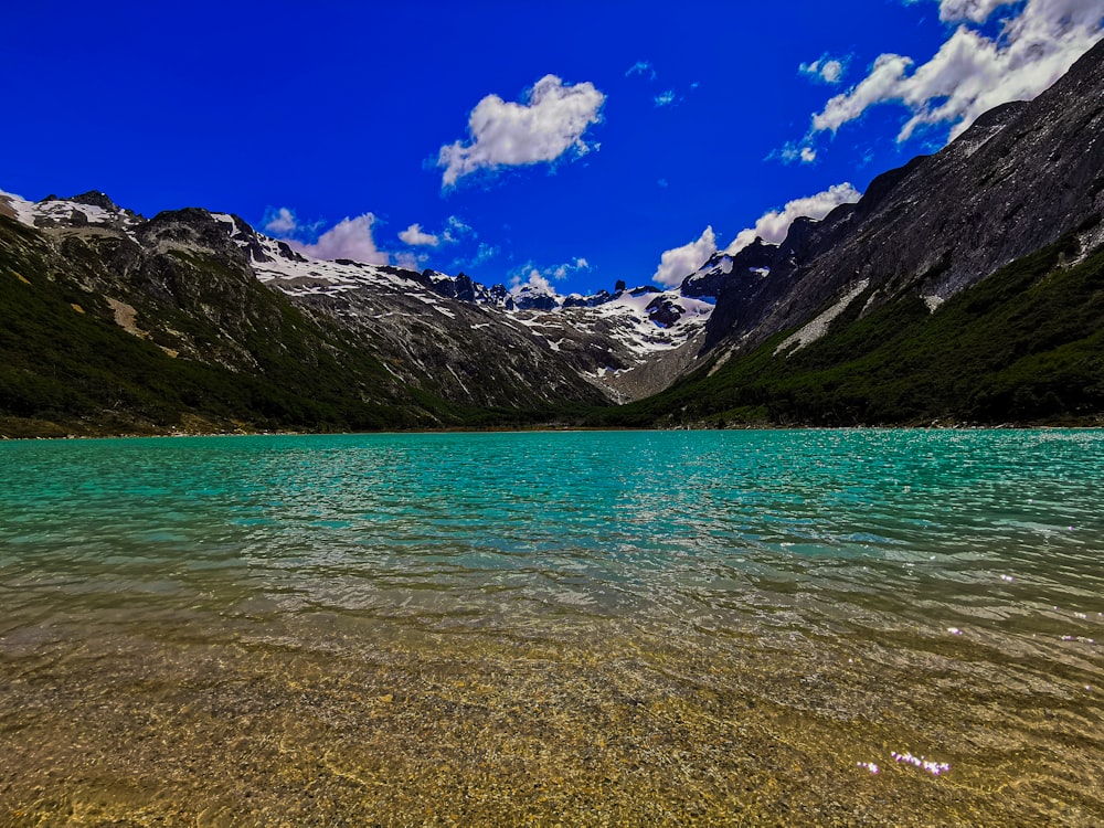 a body of water with mountains in the background