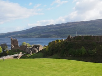 a castle on a hill by Urquhart Castle