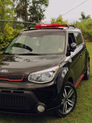 Kia Carens ready for a family trip, shown with luggage on the roof.