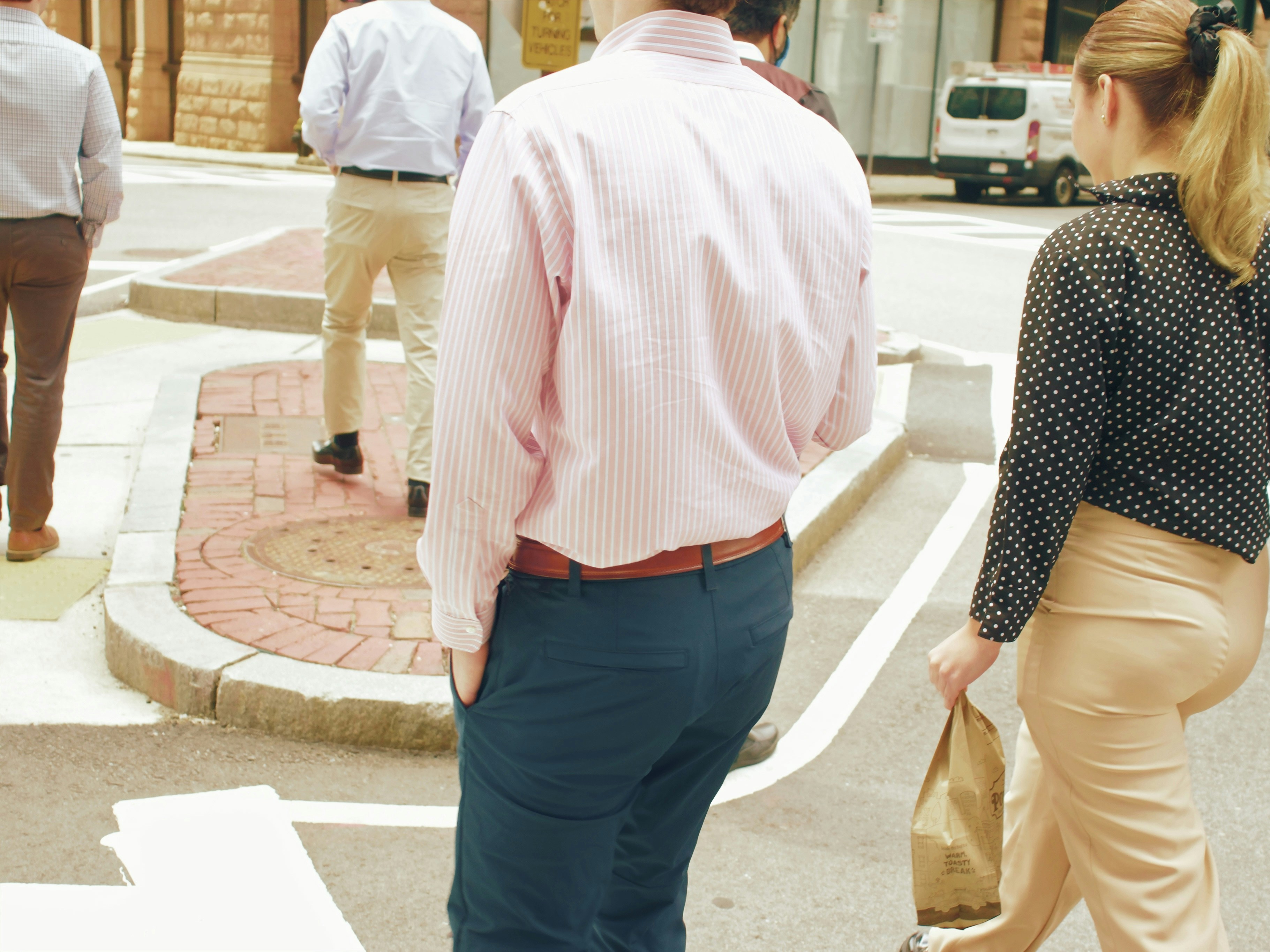 a man and woman walking down a sidewalk