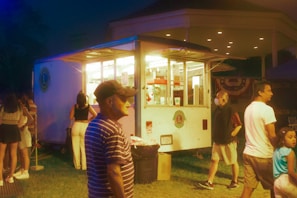 a group of people outside a food truck