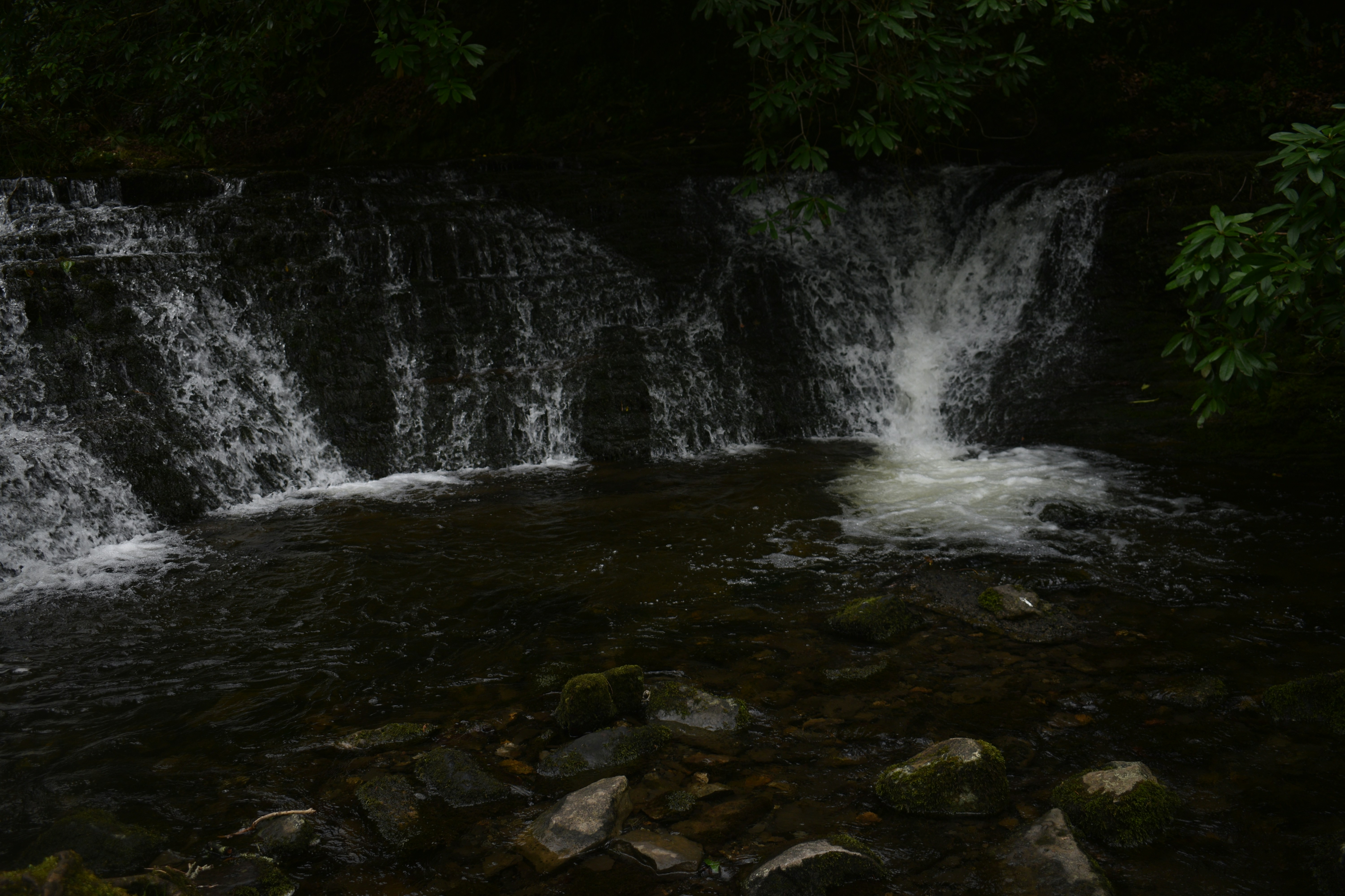 A waterfall over rocks photo – Free Grey Image on Unsplash